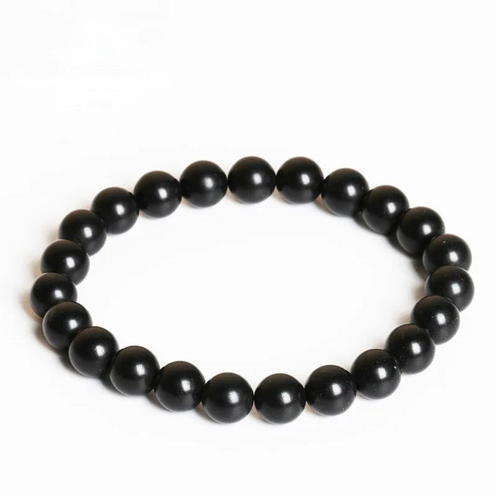 Shungite Bead Bracelet: black round shungite beads on a white background