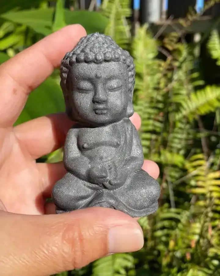 80mm black shungite Buddha carving for grounding, featuring detailed robes and curls in a serene seated meditation pose.