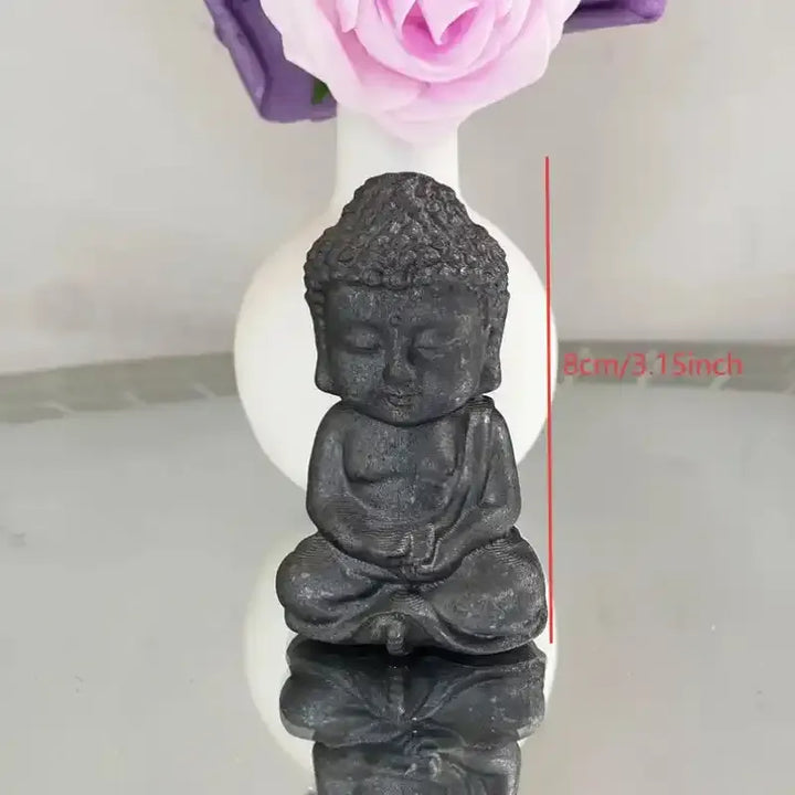 80mm black shungite Buddha carving for grounding, featuring detailed robes and curls in a serene seated meditation pose.