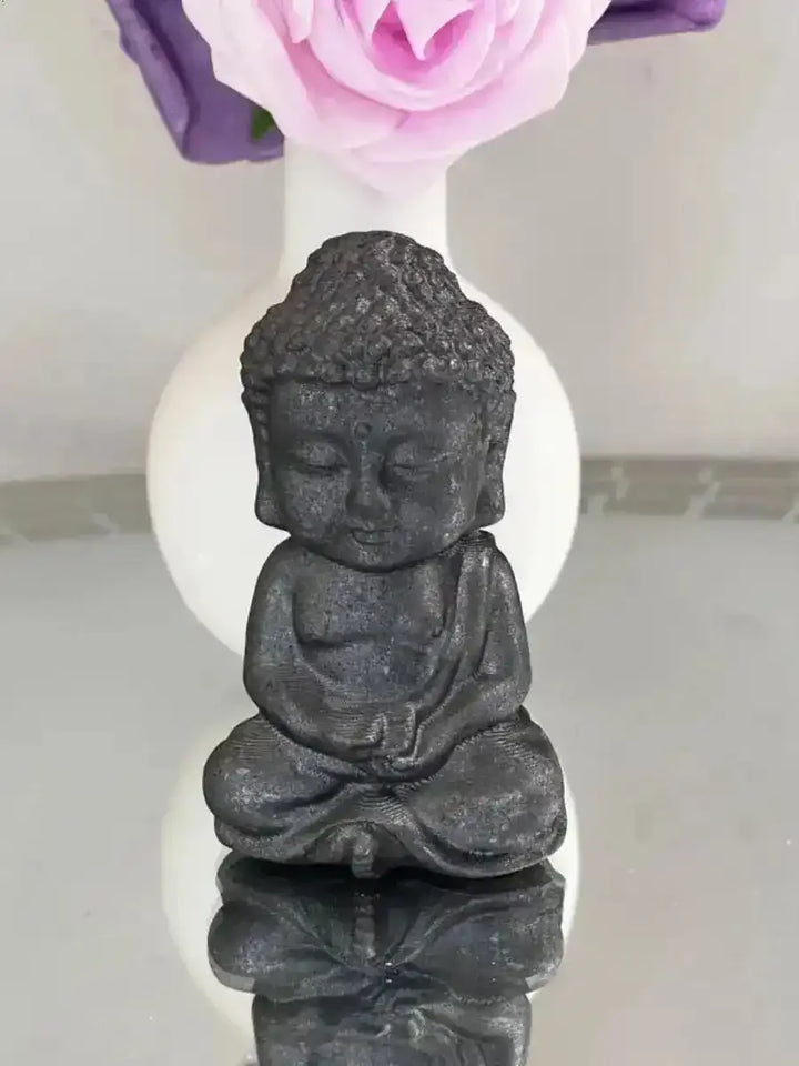 80mm black shungite Buddha carving for Root Chakra grounding, featuring detailed robes and a serene seated design.