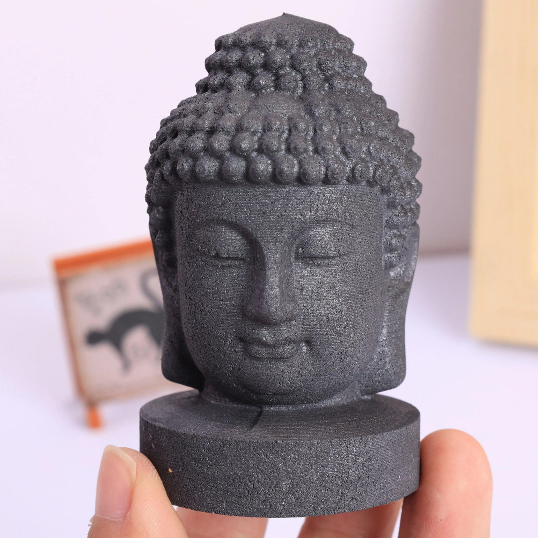 Matte black Shungite Crystal Carved Buddha Statue head for grounding and root chakra protection.