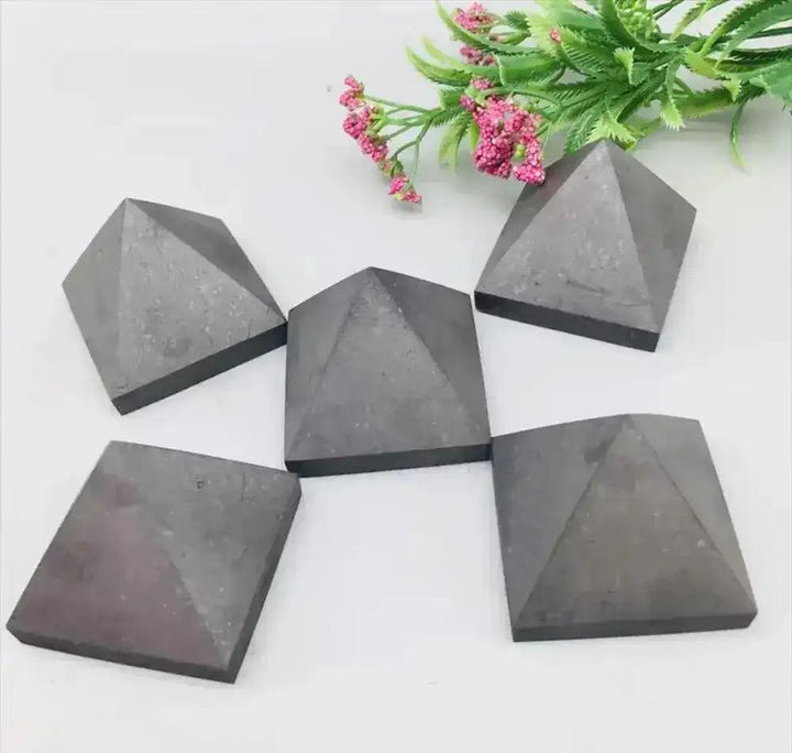 Hand-polished satin black Shungite crystal pyramids for Root chakra grounding, protection, and sacred energy work.