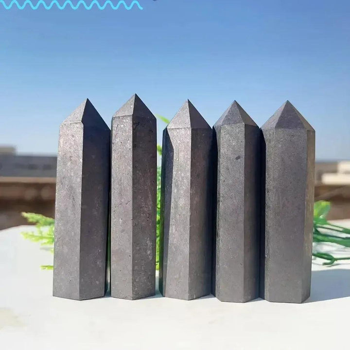 Five dark gray, polished Shungite Crystal Towers from Crystal Destiny, offering EMF protection and grounding.