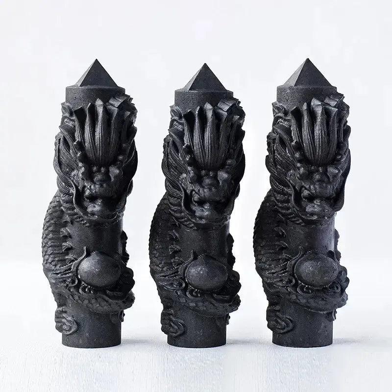 Three matte black shungite dragon tower wands from Crystal Destiny, hand-carved for protection and grounding.