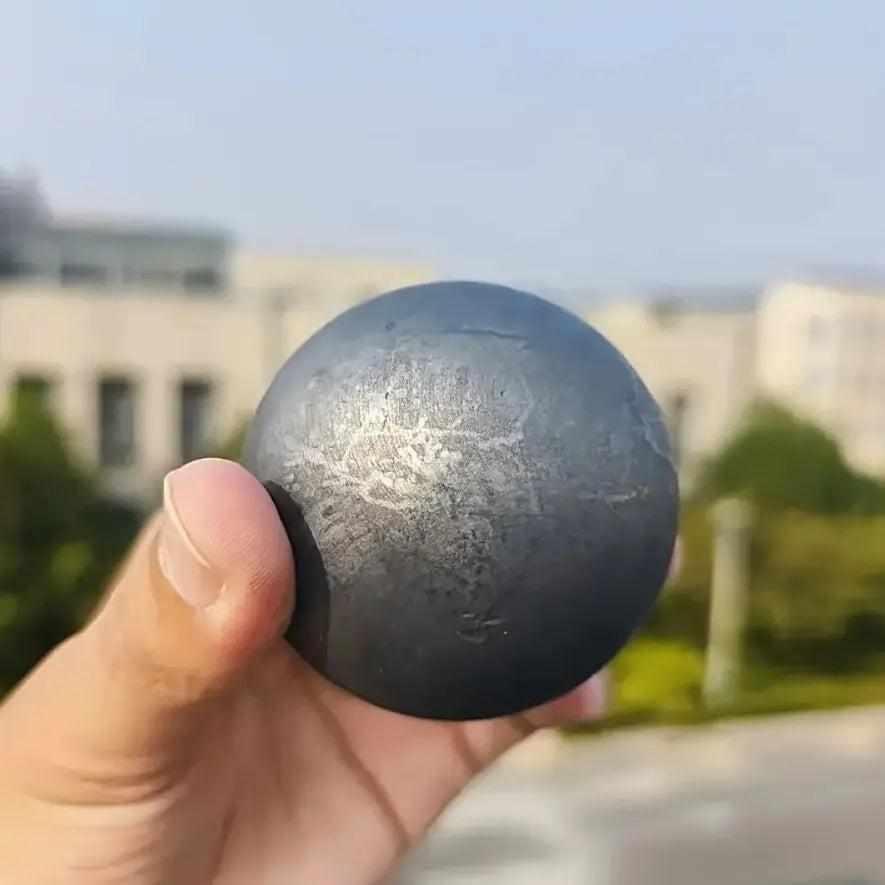 Polished black Shungite sphere with a soft metallic sheen, perfect for grounding and root chakra protection.