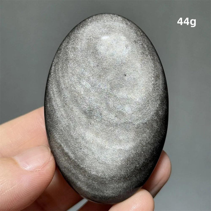 Polished 44g Silver Sheen Obsidian palm stone with a glossy black surface and reflective silvery shimmer for grounding.