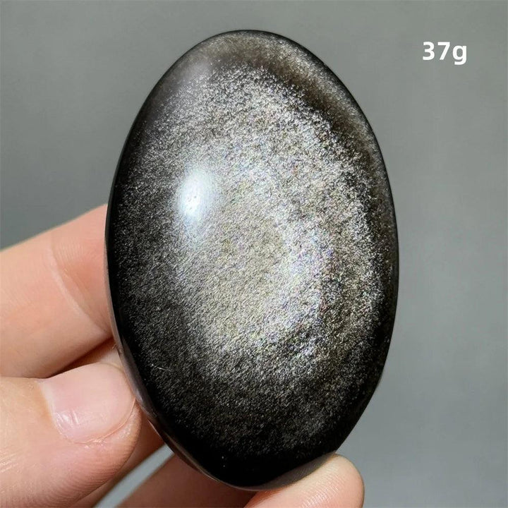 Polished 37g Silver Sheen Obsidian palm stone with a glossy black surface and shimmering silver reflection for grounding.