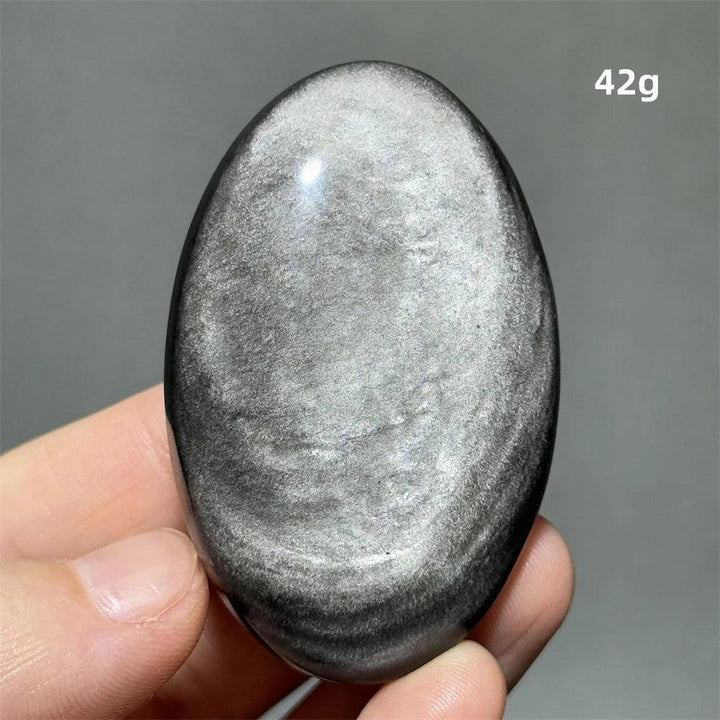 Polished 42g Silver Sheen Obsidian palm stone with a glossy black surface and reflective silvery shimmer for grounding.