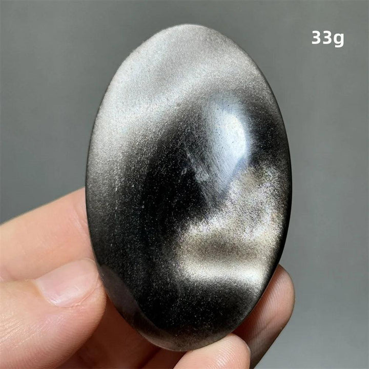 Polished 33g Silver Sheen Obsidian palm stone with a glossy black surface and radiant silvery shimmer for grounding.