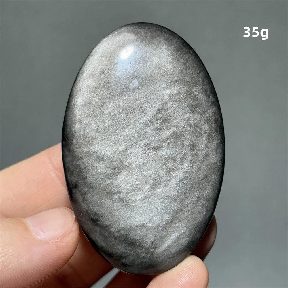 Polished 35g Silver Sheen Obsidian palm stone with a glossy black surface and reflective silvery shimmer for grounding.