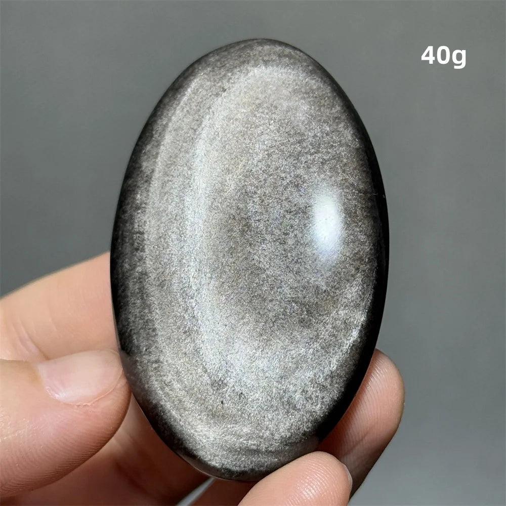 Polished 40g Silver Sheen Obsidian palm stone with a glossy black surface and reflective silvery shimmer for grounding.