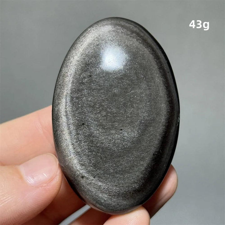 Polished 43g Silver Sheen Obsidian palm stone with a glossy black surface and reflective silvery shimmer for grounding.
