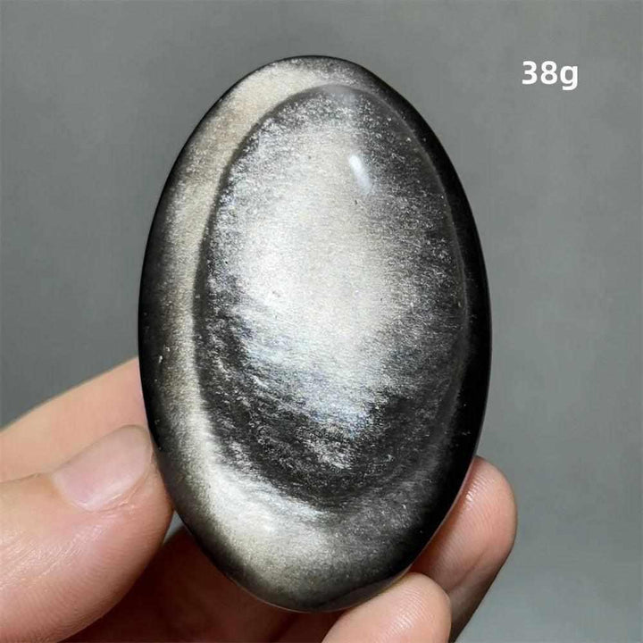 Polished 38g silver sheen obsidian palm stone with a glossy black surface and reflective silvery shimmer for grounding.
