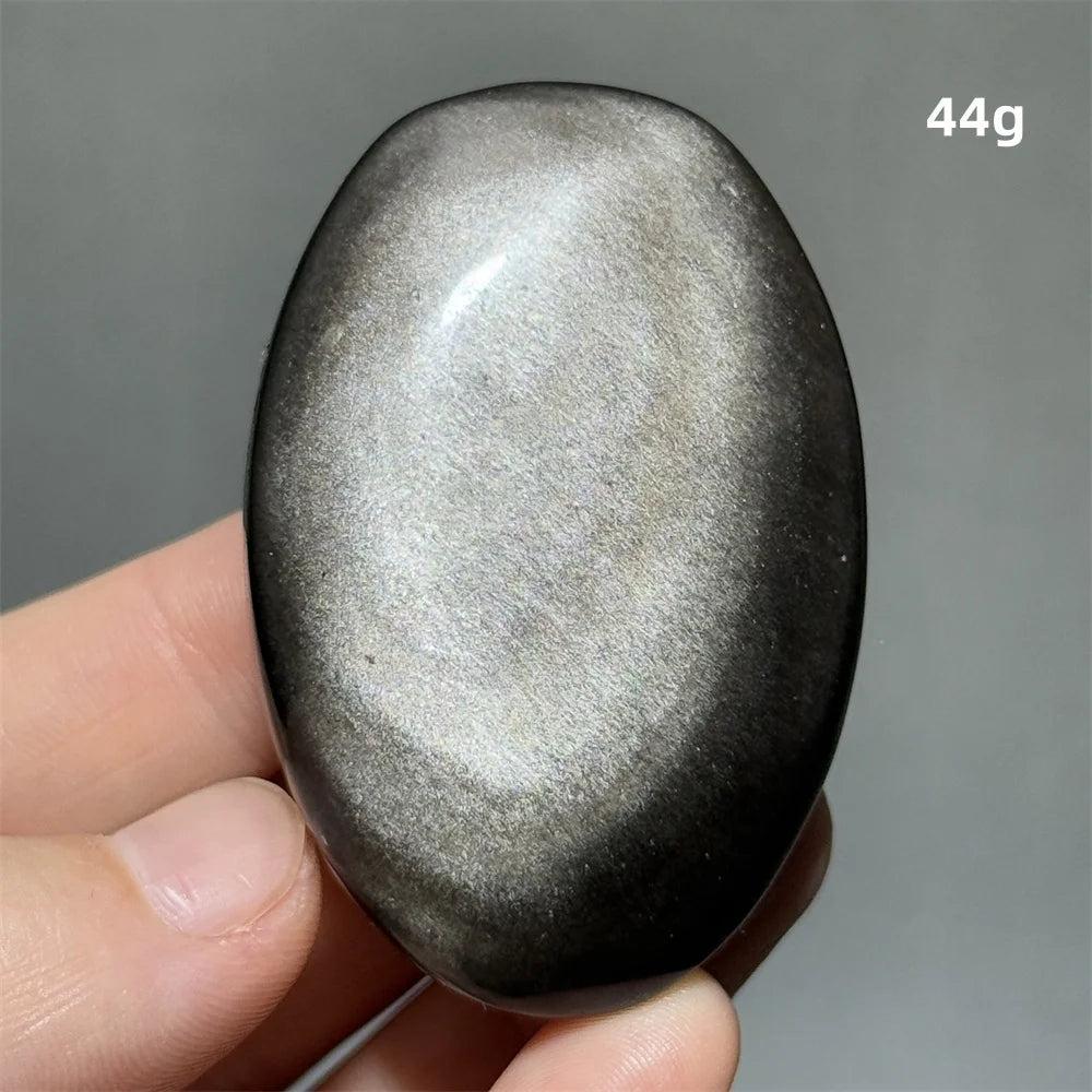 Polished 44g Silver Sheen Obsidian palm stone with a glossy black surface and reflective silvery shimmer for grounding.