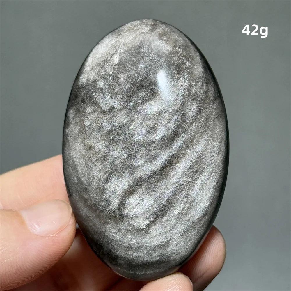 Polished 42g Silver Sheen Obsidian palm stone with a glossy black surface and reflective silvery shimmer for grounding.