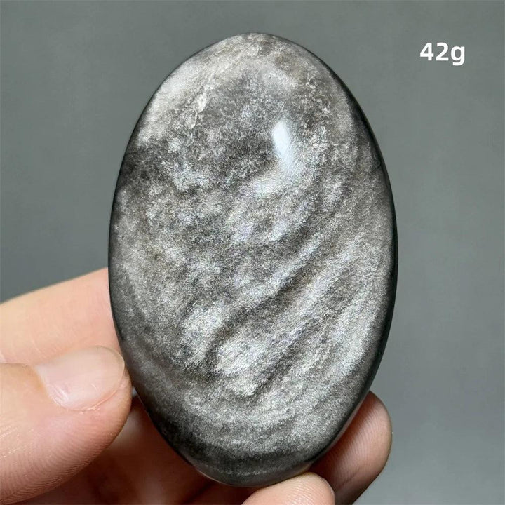 Polished 42g Silver Sheen Obsidian palm stone with a glossy black surface and reflective silvery shimmer for grounding.