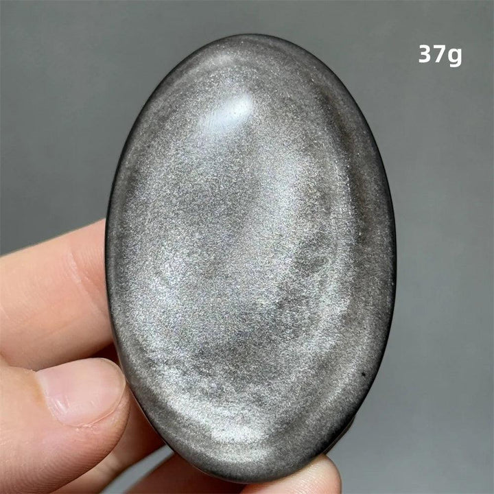 Polished 37g Silver Sheen Obsidian palm stone with a glossy black surface and reflective silvery shimmer for grounding.