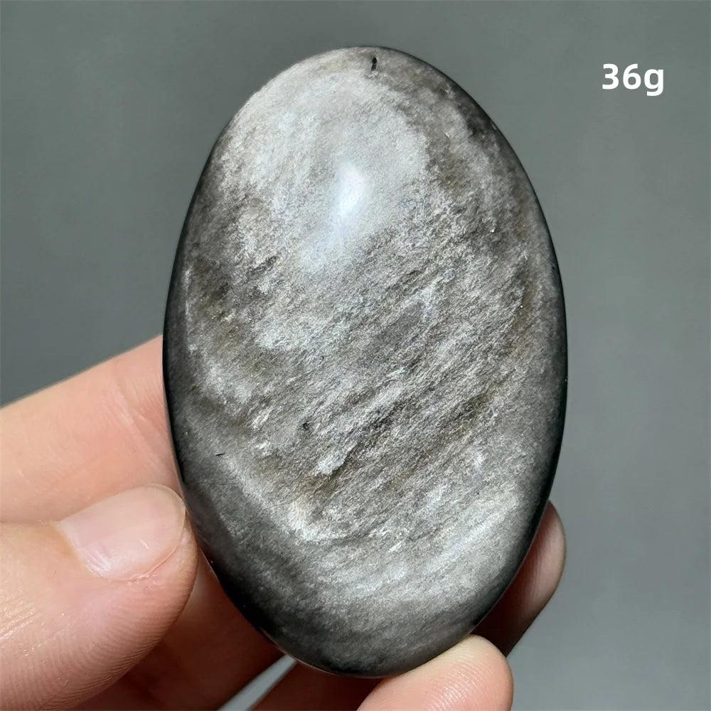 Polished 36g Silver Sheen Obsidian palm stone with a glossy black surface and reflective silvery shimmer for grounding.