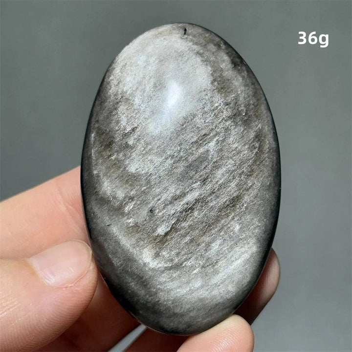 Polished 36g Silver Sheen Obsidian palm stone with a glossy black surface and reflective silvery shimmer for grounding.