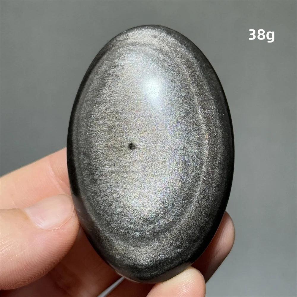 Polished 38g Silver Sheen Obsidian palm stone with a glossy black surface and shimmering silver reflection for grounding.