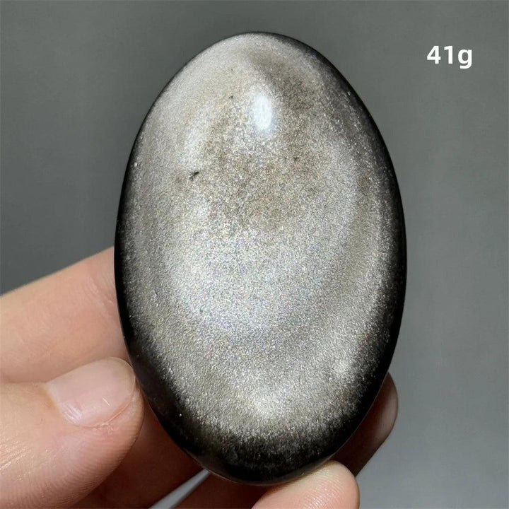 Polished 41g Silver Sheen Obsidian palm stone with a glossy black surface and reflective silvery shimmer for grounding.