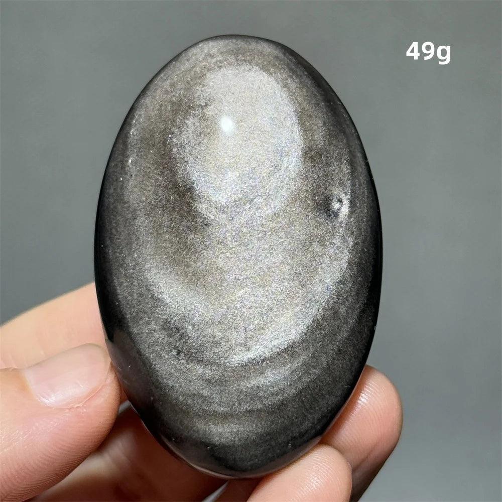 Polished 49g Silver Sheen Obsidian palm stone with a glossy black surface and reflective metallic silver shimmer.