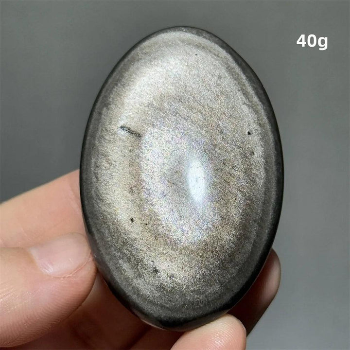 Polished 40g Silver Sheen Obsidian palm stone with a glossy black surface and reflective silvery shimmer for grounding.