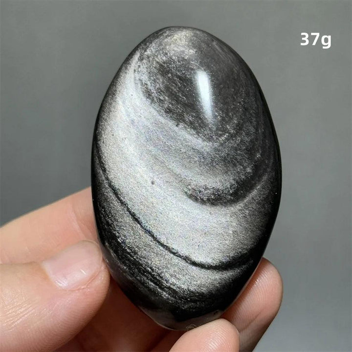 Polished 37g Silver Sheen Obsidian palm stone with a glossy black surface and radiant, grounding silvery shimmer.