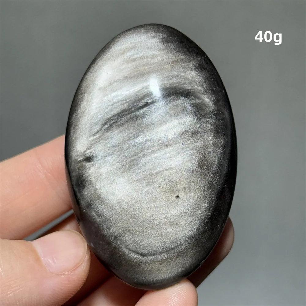 Polished 40g Silver Sheen Obsidian palm stone with a glossy black surface and reflective silvery shimmer for grounding.