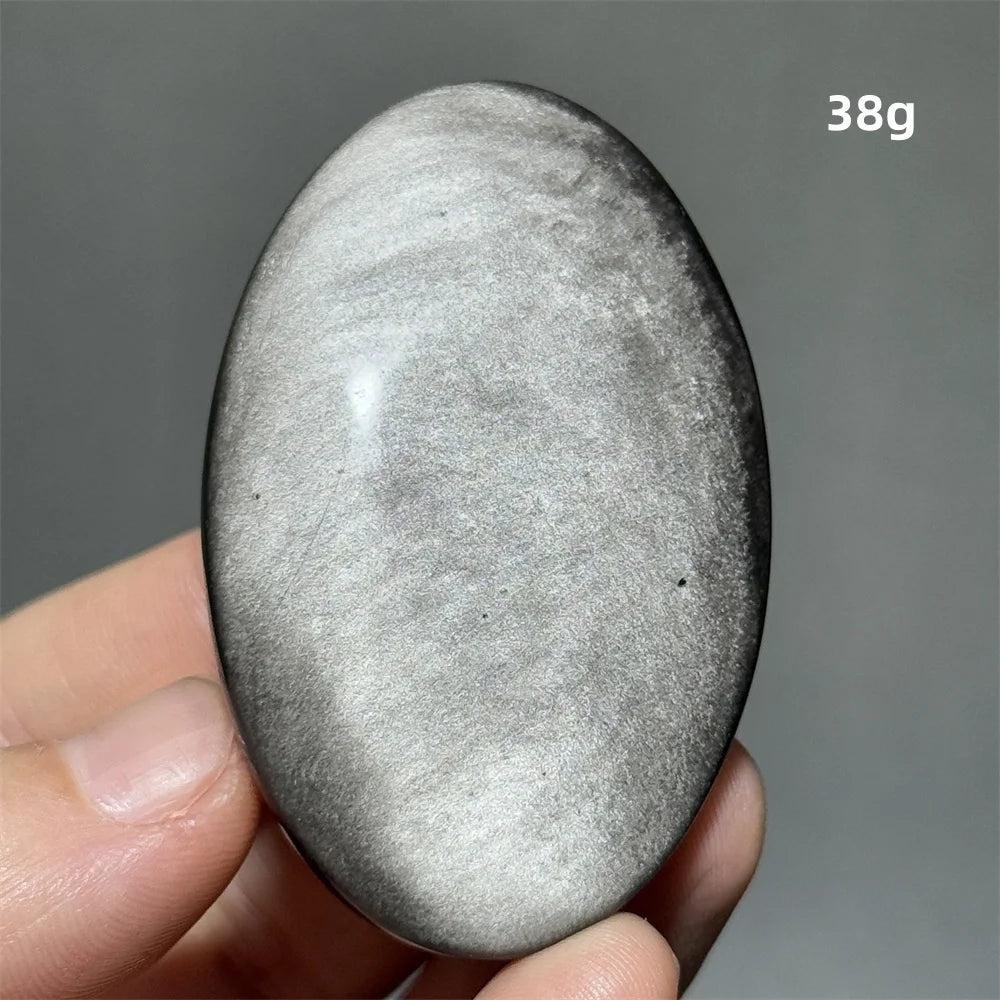 Polished 38g Silver Sheen Obsidian palm stone with a glossy black surface and shimmering metallic silver reflection.