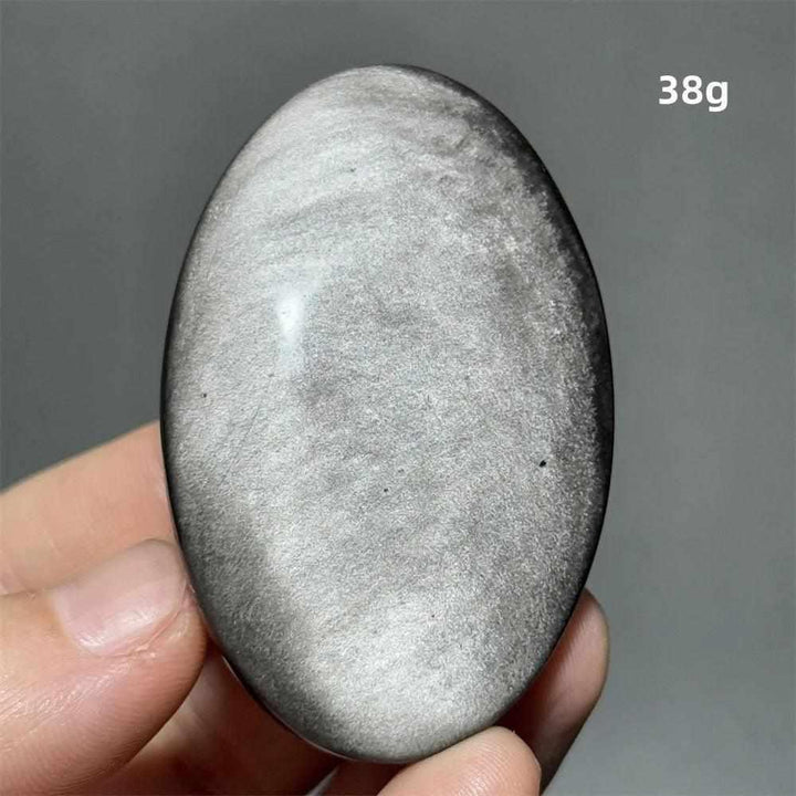Polished 38g Silver Sheen Obsidian palm stone with a glossy black surface and shimmering metallic silver reflection.