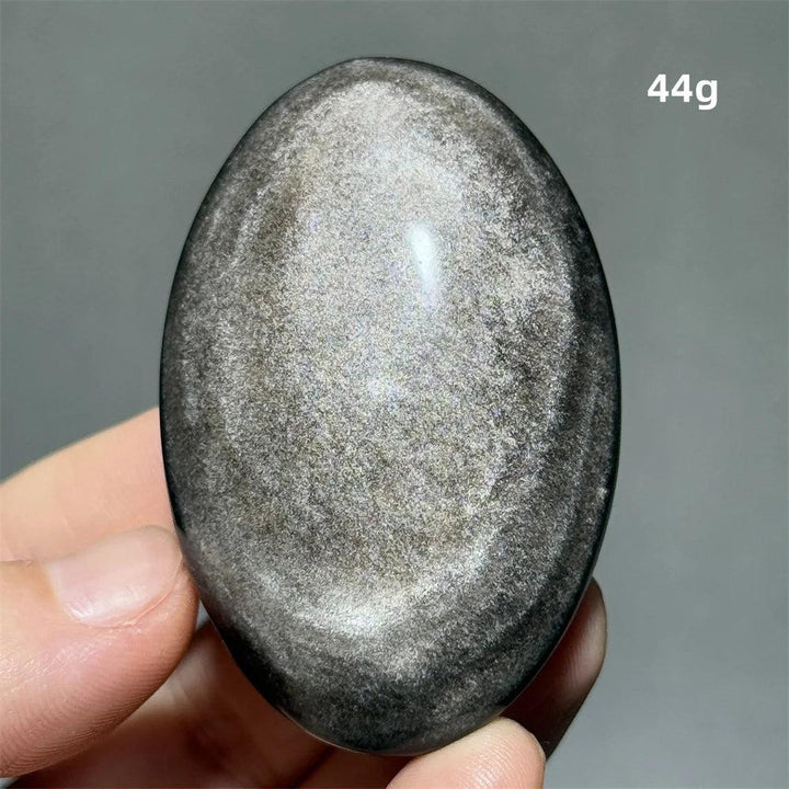 Polished 44g Silver Sheen Obsidian palm stone with a glossy black surface and shimmering silver reflection for grounding.