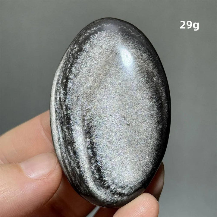 Polished 29g Silver Sheen Obsidian palm stone with a glossy black surface and radiant, grounding silvery shimmer.