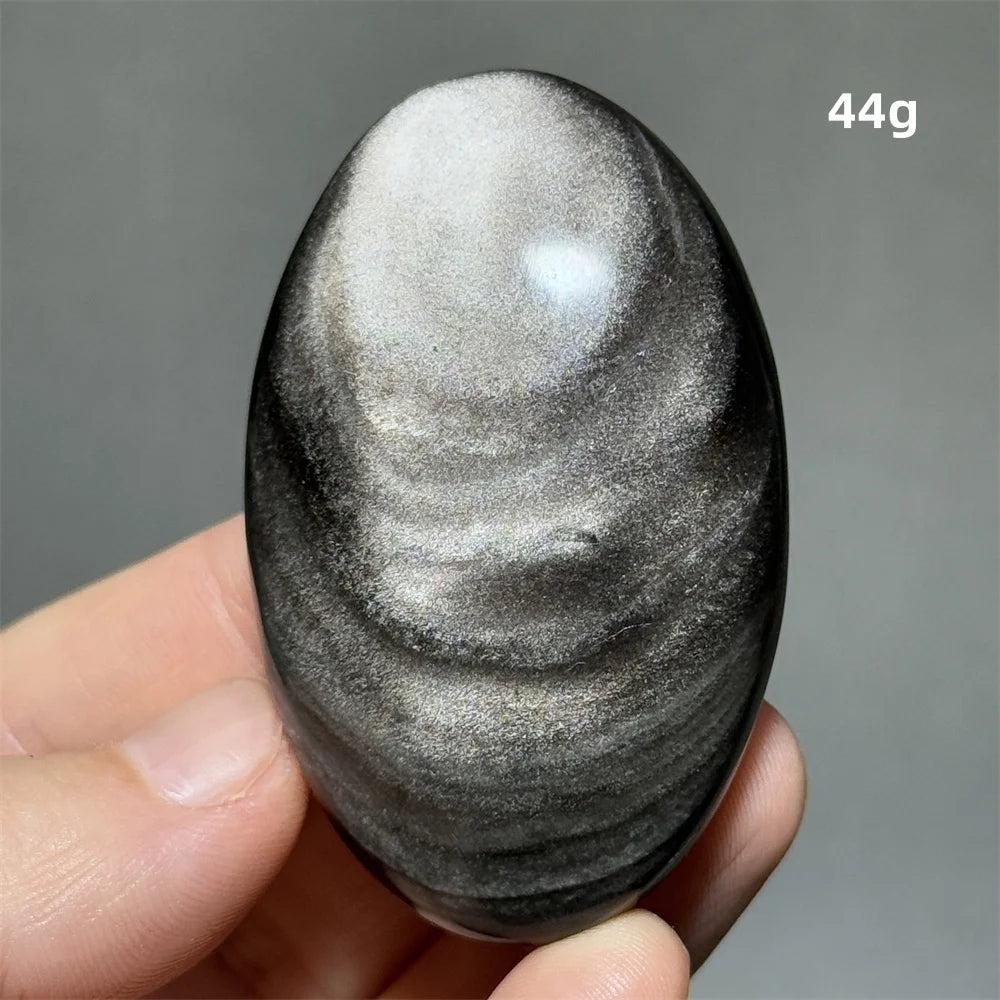 Polished 44g Silver Sheen Obsidian palm stone with a glossy black surface and reflective silvery shimmer for grounding.