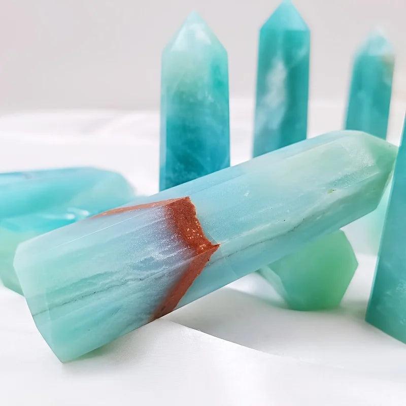 Polished sky blue quartz crystal column with a natural brown band, ideal for healing and home decor.