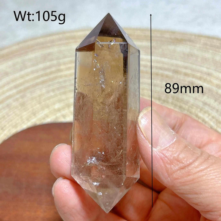 89mm smoky quartz double point crystal tower featuring natural rainbow inclusions and grounding root chakra energy.