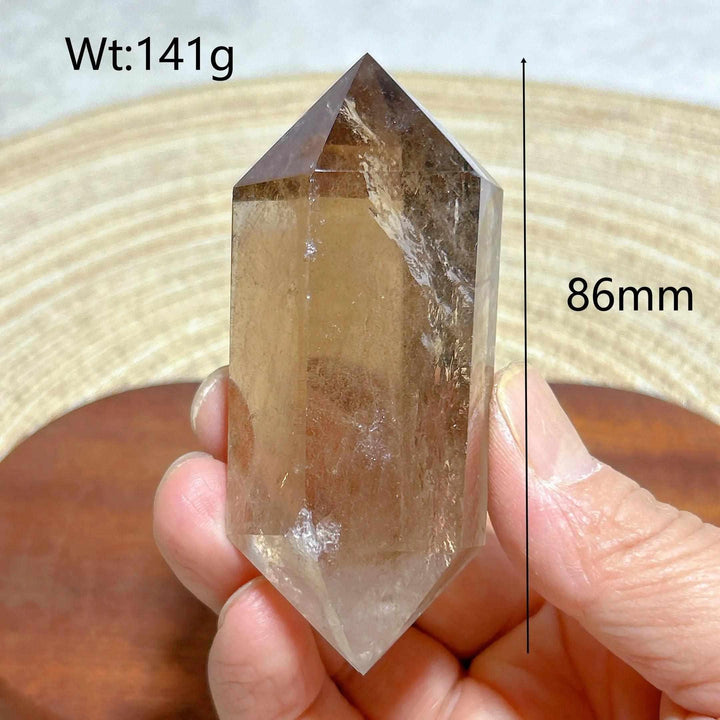 86mm smoky quartz double point crystal with natural rainbow inclusions, perfect for meditation and energy work.