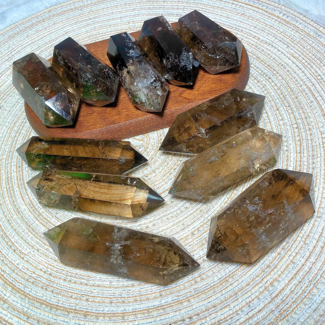 Smoky quartz double point crystals with natural rainbow inclusions, perfect for meditation and energy grid work.