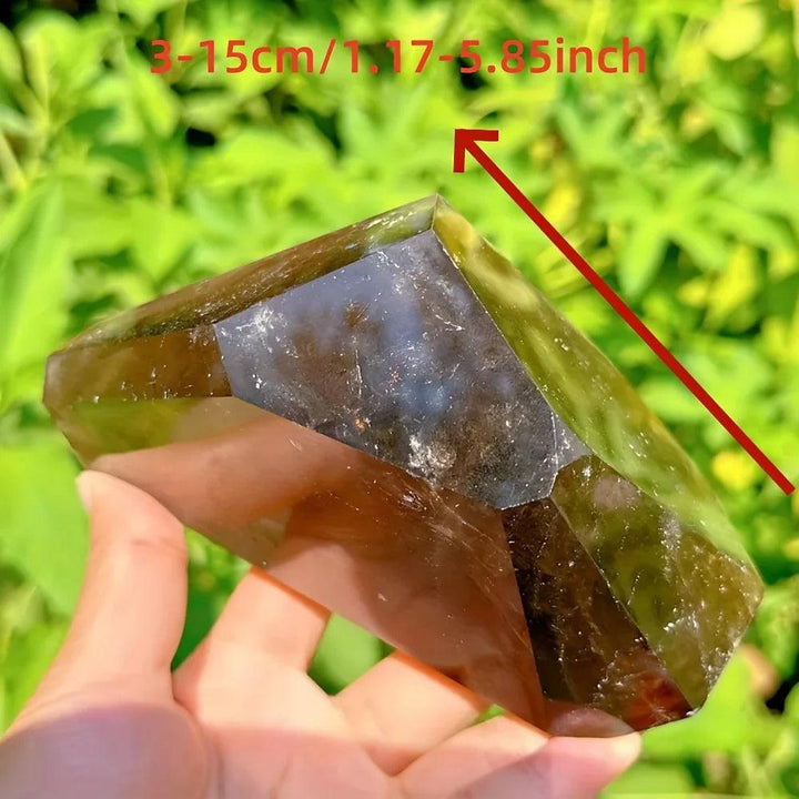 Polished dark brown Smoky Quartz freeform crystal, held in hand, showing its grounding energy and natural contours.