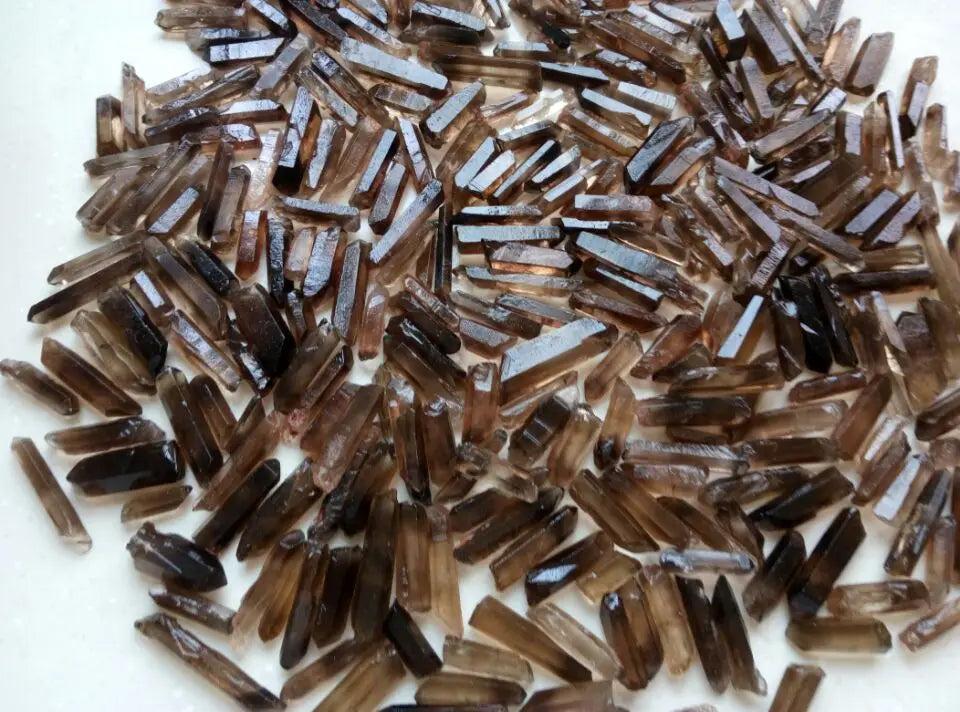 Bulk lot of natural Smoky Quartz crystal points, raw terminated wands in deep champagne to chocolate brown.