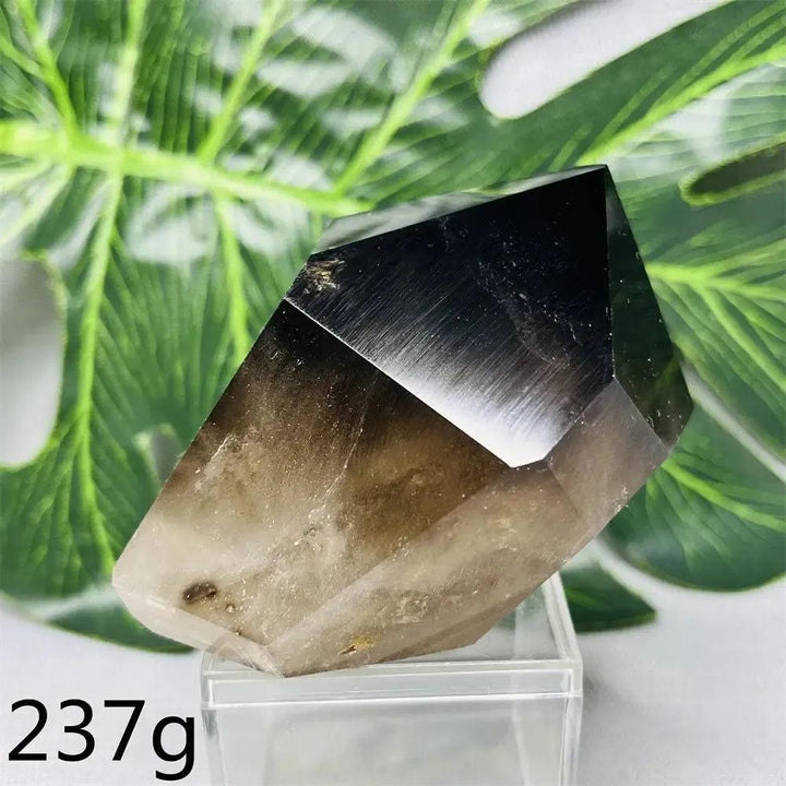 Hand-polished Smoky Quartz crystal tower from Crystal Destiny, showcasing deep brown-to-charcoal hues and a faceted top.