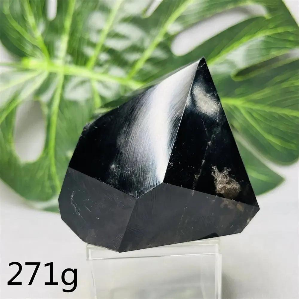 Hand-polished dark smoky quartz free-form crystal tower from Crystal Destiny, weighing 271g, with a green leaf background.