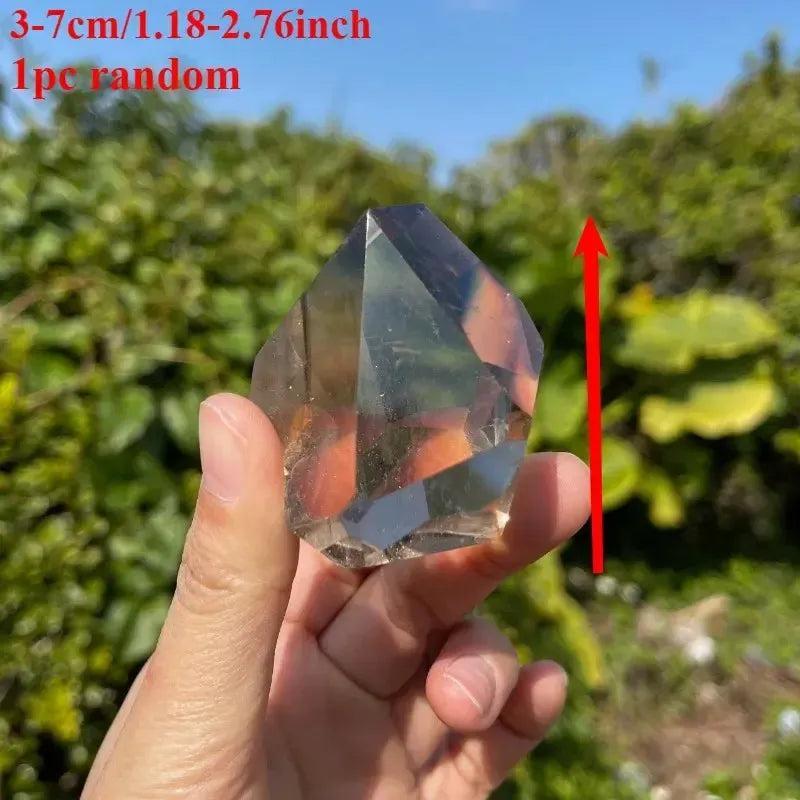 Hand holding a polished, smoky brown quartz freeform crystal, 3-7cm, for grounding from Crystal Destiny.