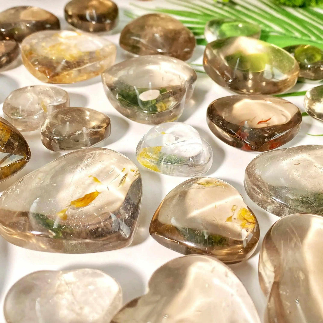 Polished smoky quartz hearts in translucent brown and gray tones, perfect for grounding and Root Chakra healing.