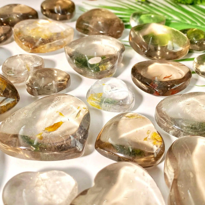 Polished smoky quartz hearts in translucent brown and gray tones, perfect for grounding and Root Chakra healing.