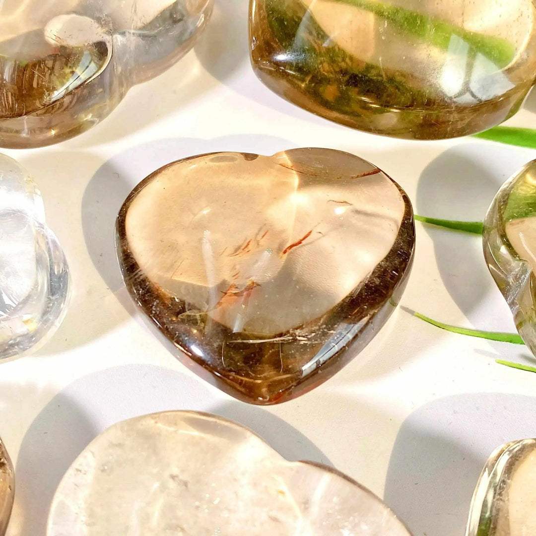Polished smoky quartz heart with translucent brown and gray tones, perfect for grounding and Root Chakra healing.