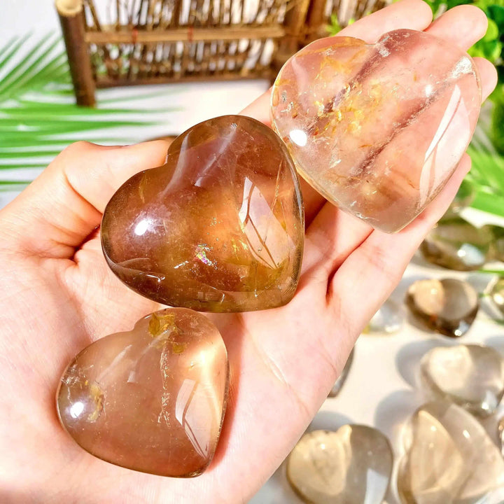 Polished smoky quartz hearts in shades of brown and gray, perfect for grounding and Root Chakra healing.