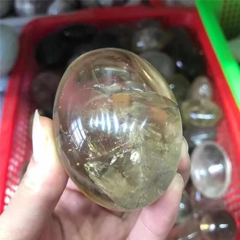 Smooth, translucent smoky quartz palm stone with grounding brown tones, perfect for meditation and stress relief.
