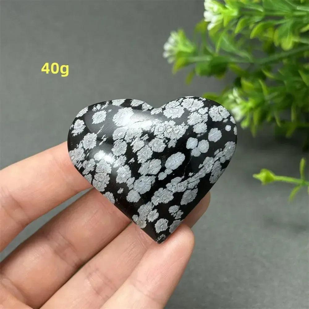 Polished Snowflake Obsidian Crystal Heart, 40g, showcasing black volcanic glass with white snowflake patterns for grounding and healing.