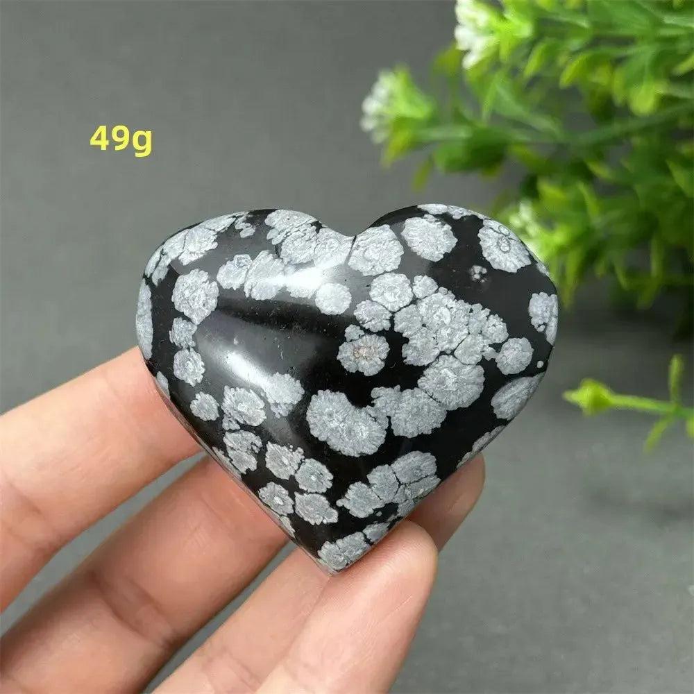 Polished Snowflake Obsidian Crystal Heart, black with white snowflake patterns, for grounding and emotional balance.
